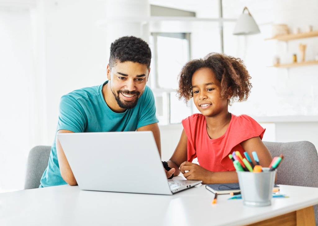 Child learning with instructor at computer